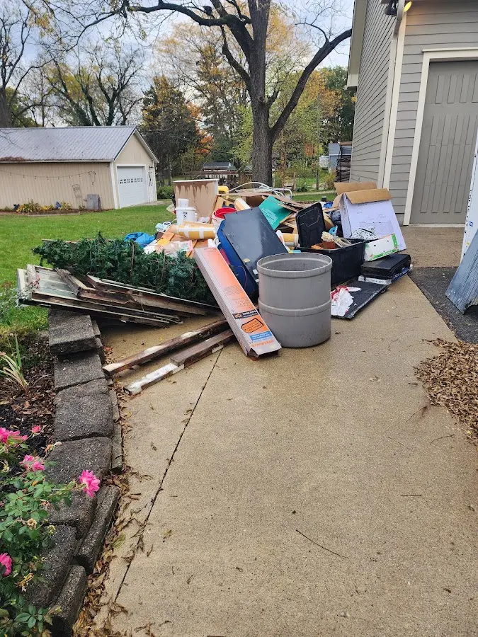 Dumpster being loaded with debris for Estate Cleanout Dumpster Rental in Golden Valley